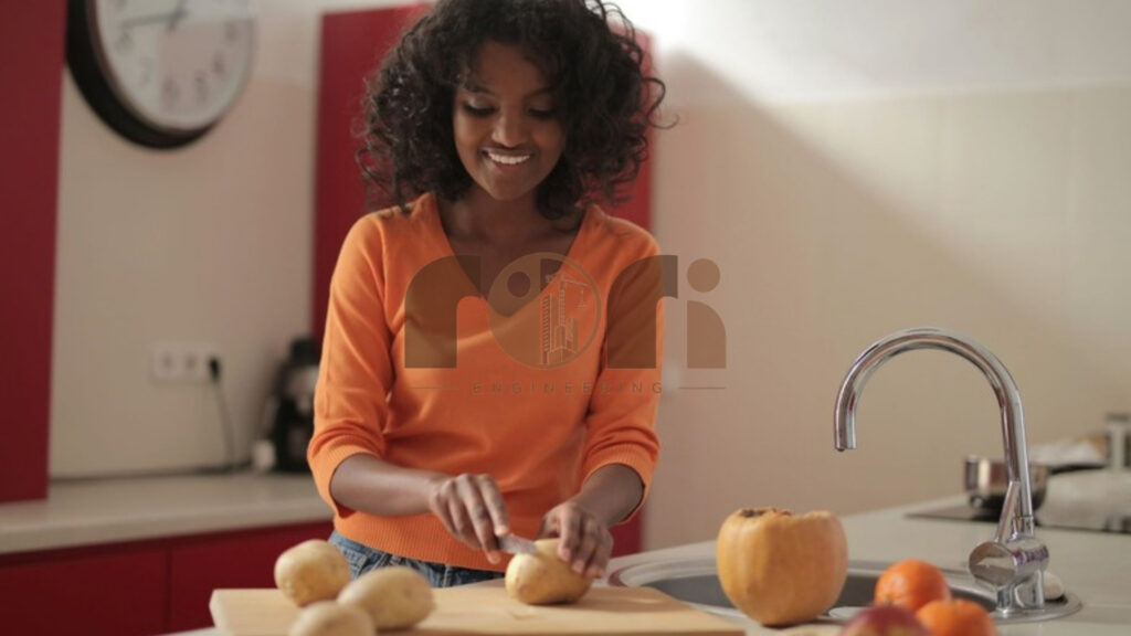 Woman preparing food in a modern kitchen, illustrating kitchen design in Rwanda